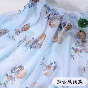 May include: Light blue fabric with a floral pattern in shades of pink, orange, and green. The fabric has a translucent quality and is draped. The text "2# ancient style light blue" is visible.