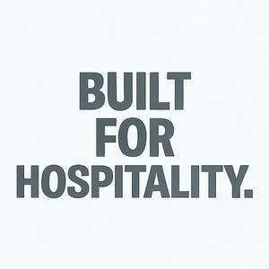 Może przedstawiać: Na białym tle tekst "BUILT FOR HOSPITALITY" w ciemnoszarej, bezszeryfowej czcionce. Tekst jest wyśrodkowany i zajmuje większość obrazu.