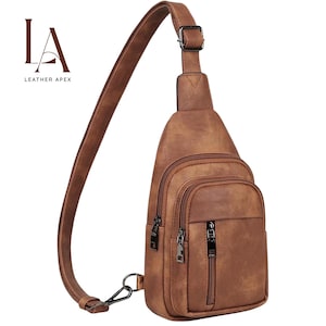 May include: Brown leather sling bag with multiple zippered compartments and an adjustable shoulder strap. The bag features a metal clasp and buckle, and the brand logo "LA LEATHER APEX" is visible in the upper left corner.