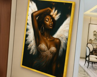 May include: A framed canvas art print depicting a dark-skinned figure with white feathered wings, gold hoop earrings, and a gold-trimmed frame. The figure wears a gold top and has an arm raised. The background is dark.