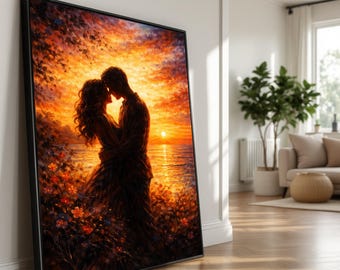 May include: Framed art print depicting a couple embracing at sunset. The artwork features warm colors, including orange, yellow, and red, with a silhouette of the couple against the setting sun over the water. Flowers and foliage are in the foreground.