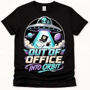 May include: A black t-shirt featuring a graphic of an alien in a UFO beaming up a laptop with a BRB note, a notebook, a pen, and a coffee mug. The text reads OUT OF OFFICE, INTO ORBIT in bold, colorful lettering, surrounded by planets and clouds.