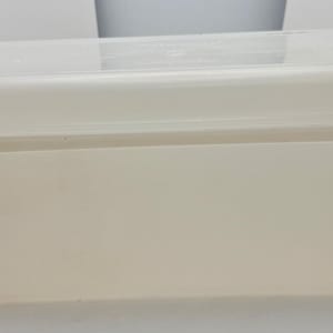 May include: A rectangular, off-white plastic container with a matching lid. The container has a slightly translucent appearance and a simple, functional design. The lid fits snugly, suggesting a storage purpose. The overall aesthetic is clean and utilitarian.