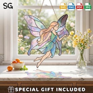 May include: A stained glass suncatcher featuring a fairy with iridescent wings in shades of purple, blue, and pink. The fairy has long hair and wears a green and blue dress. It hangs by a gold chain in front of a window, casting a colorful reflection.