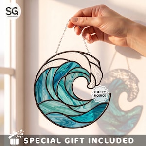 May include: A circular stained glass suncatcher featuring a stylized ocean wave design in shades of teal, turquoise, and clear textured glass with dark metal soldering. A small white circular sticker with the text HOPPY LICENCE is attached.