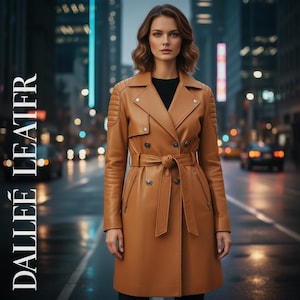 May include: A tan leather trench coat with a belted waist and button details. The coat has quilted shoulder accents and is worn by a person standing in front of a city backdrop. The text "DALLEE LEATER" is printed vertically on the left side.