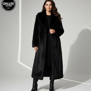 May include: A full-length black fur coat with a wide collar. The coat is worn over a black outfit and black boots. The Dallee Leather logo is in the upper left corner.