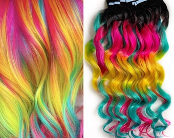 May include: Rainbow colored clip-in hair extensions with wavy hair. The extensions are in shades of pink, yellow, green, and blue.