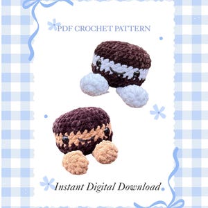 May include: Two plush, crocheted creatures resembling cookies, one brown and white, the other brown and tan, each with small black eyes and smiling faces. The image includes the text "PDF CROCHET PATTERN" and "Instant Digital Download."
