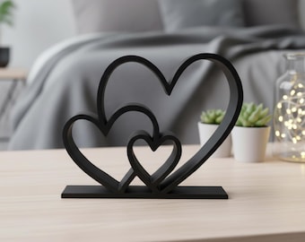 Schwarze ineinander greifende Herz-Statue - Moderne Liebe Skulptur