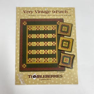May include: A pattern booklet titled Very Vintage 9-Patch by Thimbleberries by Lynette Jensen. The cover displays a quilt and pillows in dark green, red, and gold tones with floral motifs. The text indicates a size of 66 x 78-inches.