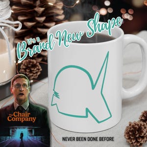 May include: White ceramic mug with a teal outline design and the text "It's a Brand New Shape". The mug has a handle and is filled with a dark liquid. The text "NEVER BEEN DONE BEFORE" is at the bottom.
