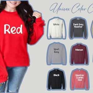 May include: A red sweatshirt with the word "Red" in white lettering. The image also displays a colour chart of sweatshirts in various colours, including white, grey, maroon, and green. The chart is labelled "Unisex Colour Chart."