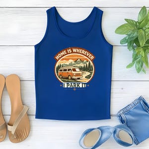 May include: A blue tank top with a circular graphic featuring an orange camper van driving on a road in front of mountains. The text reads "HOME IS WHEREVER I PARK IT".