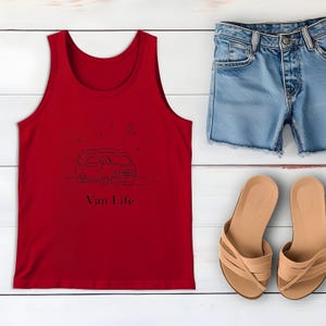 May include: A red tank top with a black line drawing of a van, stars, and a crescent moon. The text "Van Life" is below the drawing. Light blue denim shorts and tan sandals are also in the image.