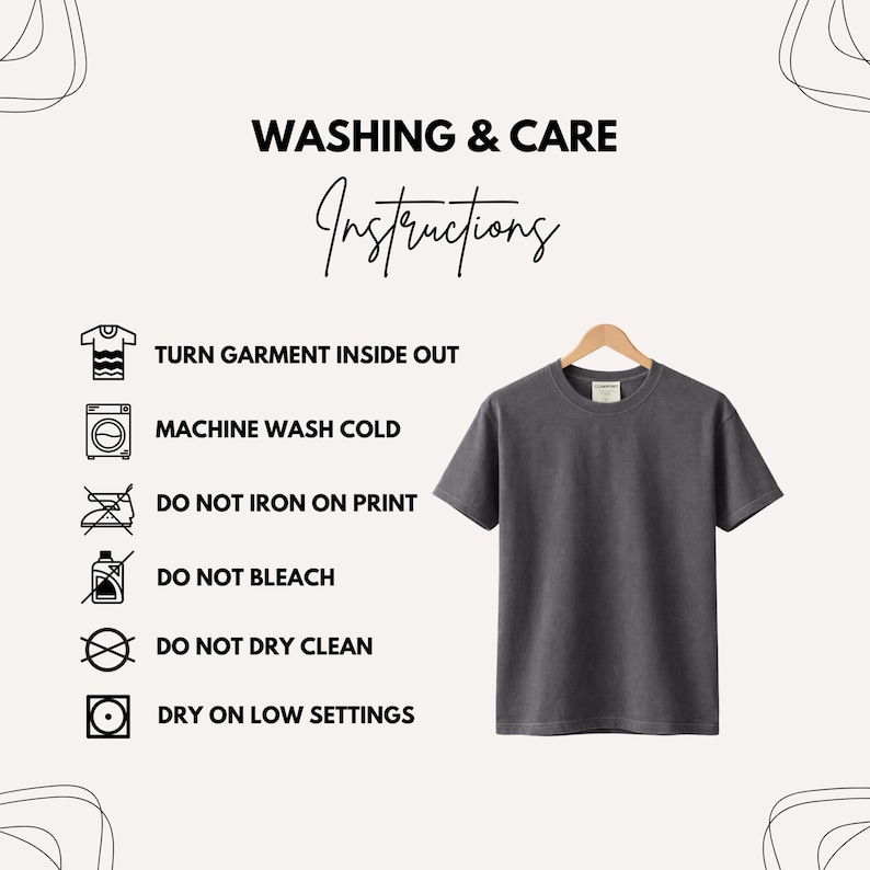 May include: A charcoal gray short-sleeve t-shirt hanging on a wooden hanger. The image includes washing instructions: turn garment inside out, machine wash cold, do not iron on print, do not bleach, do not dry clean, and dry on low settings.