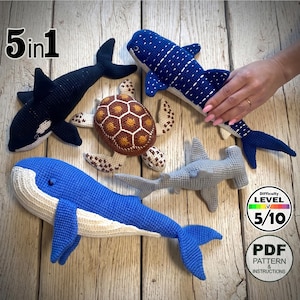 May include: A collection of five crocheted sea creatures: a blue whale, a killer whale, a whale shark, a sea turtle, and a hammerhead shark. The difficulty level is 5/10. The image also includes a PDF pattern and instructions.