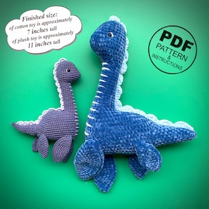 May include: Two crocheted dinosaur plush toys, one purple and one blue, on a green background. The blue dinosaur is approximately 11 inches tall. The purple dinosaur is approximately 7 inches tall. A PDF pattern is available.