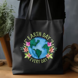 May include: Black tote bag with a colorful Earth Day design. The design features a watercolor image of the Earth surrounded by flowers and the text "Earth Day Every Day" in a circular arrangement.