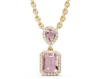 May include: A gold-toned necklace featuring a pear-shaped and emerald-cut pink gemstone pendant, both surrounded by a halo of small, clear gemstones. The necklace has a delicate chain.