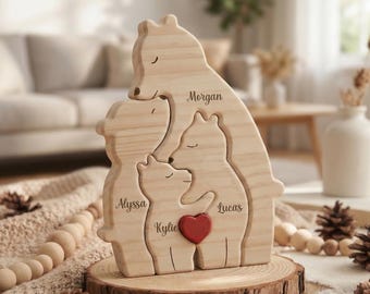 May include: A wooden family bear figurine with the names Morgan, Alyssa, Kylie, and Lucas engraved on it. The bear family is on a wooden base with a red heart. The figurine is surrounded by pine cones and wooden beads.