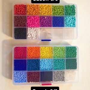 May include: Two clear plastic bead organizers filled with colorful seed beads. The top organizer is labeled "Czech 6/0" and the bottom one is labeled "Czech 8/0". The beads are in various colors, including red, orange, yellow, green, blue, and purple.