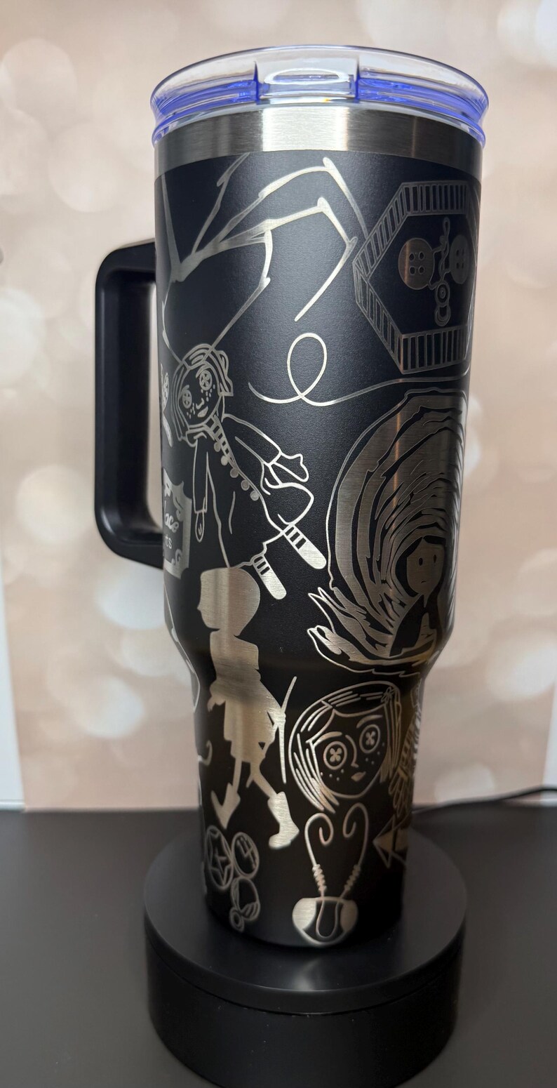 May include: A white ceramic mug with a black handle and the text "But First, Coffee" in a bold, black font. The mug is sitting on a wooden surface. The mug is approximately 4 inches tall.