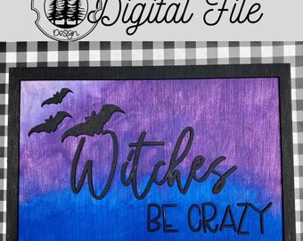 May include: A wooden sign with a purple and blue ombre background. The sign has a black frame and the text "Witches Be Crazy" in black lettering. There are three black bats flying in the upper left corner of the sign.