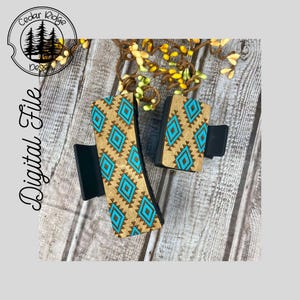 May include: Two wooden hair clips with a geometric pattern in shades of brown and turquoise. The clips are on a wooden surface.