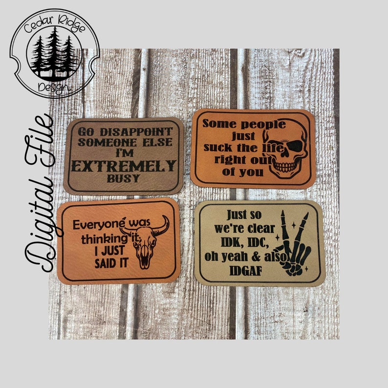 May include: Four brown leather coasters with black text and images. The coasters feature the following sayings: "Go disappoint someone else I'm extremely busy", "Some people just suck the life right out of you", "Everyone was thinking it, I just said it", and "Just so we're clear IDK, IDC, oh yeah & also IDGAF".