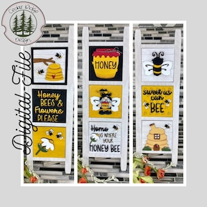 May include: Three wooden signs with a bee theme. The first sign says "Honey Bees & Flowers Please" with a bee and a flower. The second sign says "Home is where your Honey Bee" with a bee and a jar of honey. The third sign says "Sweet as can BEE" with a bee and a beehive.