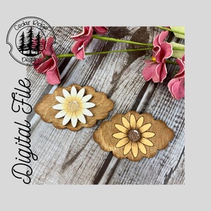 May include: Two wooden flower shapes with a brown background and yellow and white flower designs. The flowers have a glitter centre.