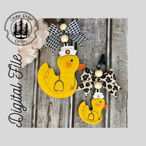 May include: Two wooden nurse duck ornaments with a red cross on their hats. The larger duck has a stethoscope around its neck. Both ducks are yellow with black eyes and beaks. The larger duck is paired with a black and white checked bow and the smaller duck is paired with a leopard print bow.