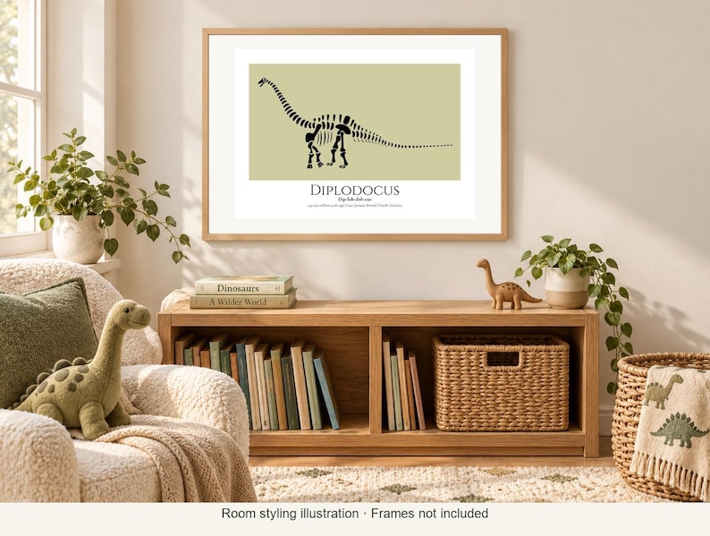 May include: A framed wall art print featuring a black silhouette of a Diplodocus dinosaur skeleton on a light olive green background. The text below the dinosaur reads DIPLODOCUS, followed by smaller descriptive text in a serif font.
