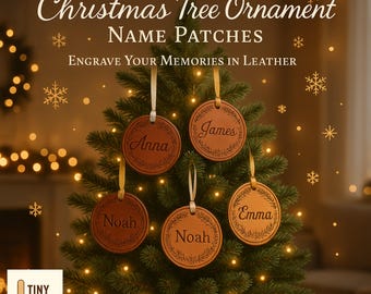 May include: Custom Christmas tree ornaments with name patches hanging on a decorated Christmas tree. The ornaments are round, brown leather with names engraved in a decorative font. The text "Engrave Your Memories in Leather" is also visible.