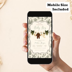 K&ouml;nnte beinhalten: Eine digitale Babyparty-Einladung auf einem Smartphone-Bildschirm mit cremefarbenem Hintergrund und einem dunkelgr&uuml;nen Tannenbaummuster. Der Text lautet 'Tis the season for a baby boy' mit Illustrationen von Babykleidung an einer Leine.