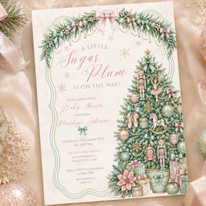 May include: A rectangular baby shower invitation card featuring a Christmas tree decorated with nutcrackers, ballerinas, and ornaments. The text reads A LITTLE SUGAR PLUM IS ON THE WAY, with details for Penelope Johnson on Saturday, December 10th at 2:00 PM.