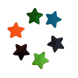May include: A collection of six star-shaped patches in various colors: orange, green, blue, black, light green, and brown. Each patch has a textured surface, and they are arranged in a circular pattern against a white background. These patches are suitable for crafts and DIY projects.