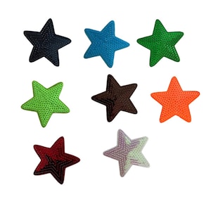 May include: A collection of nine star-shaped patches in various colors, including navy blue, teal, green, lime green, brown, orange, burgundy, and a light purple and green mix. Each patch has a textured surface.