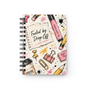May include: A spiral-bound notebook featuring a cream-colored cover with a printed illustration of office supplies including a coffee cup labeled MHR, a pink highlighter, a pencil, a paperclip, a binder clip, and a note reading Fueled by Drop-Off.