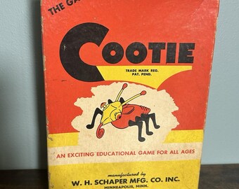 Könnte beinhalten: Vintage Cootie Brettspielbox. Die Box ist rot mit schwarzem und gelbem Text und einer Cartoon-Illustration eines Käfers. Der Text lautet "The Game of Cootie" und "An Exciting Educational Game for All Ages."