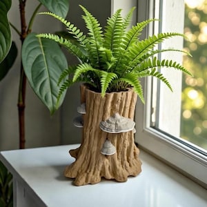 May include: A decorative planter shaped like a tree stump, featuring a vibrant green fern. The planter is a light brown color with several mushroom-shaped accents. The fern has many small, green leaves.