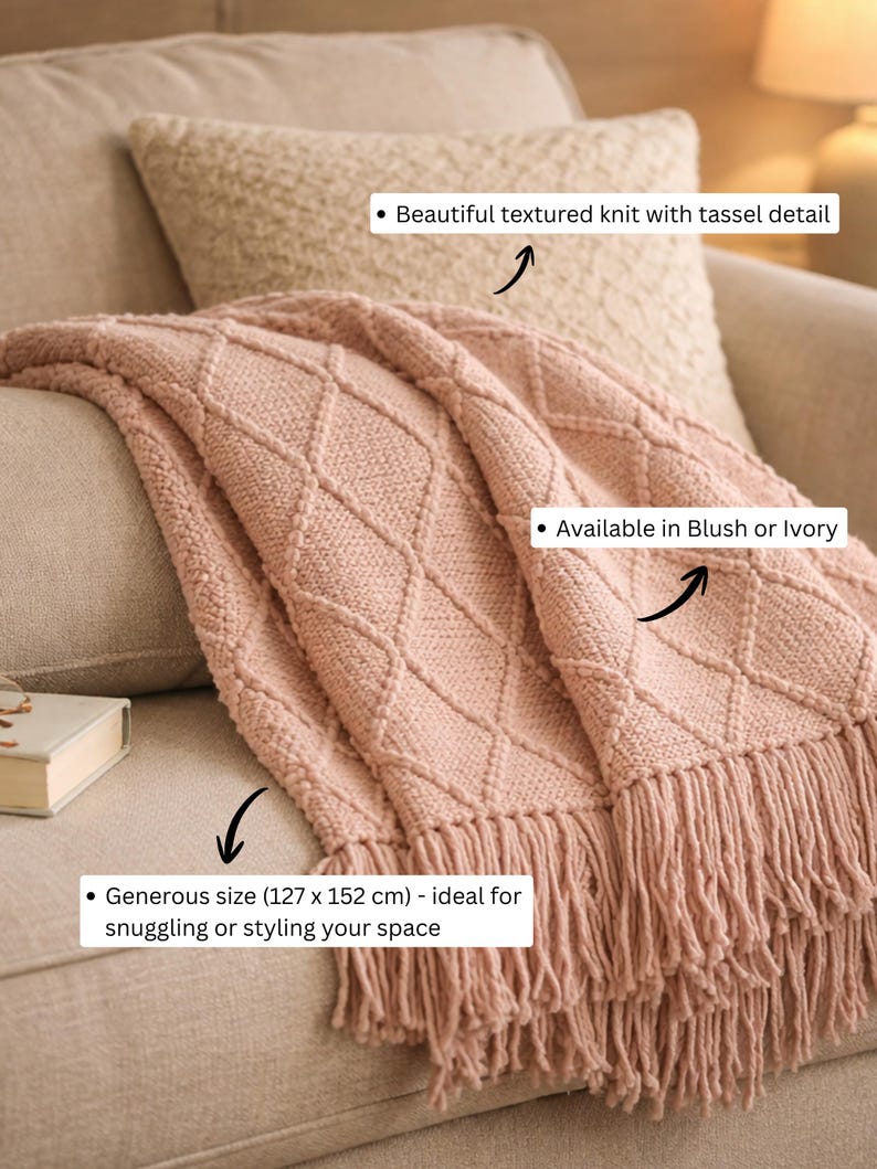 May include: A blush pink knit throw blanket featuring a diamond pattern and fringe trim. The blanket measures 127 cm by 152 cm. The text on the image includes: Beautiful textured knit with tassel detail, Available in Blush or Ivory, and Generous size (127 x 152 cm) - ideal for snuggling or styling your space.