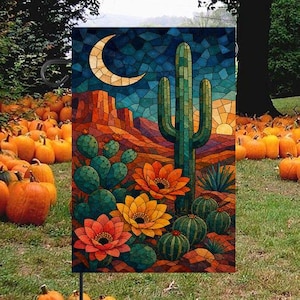 May include: A rectangular garden flag featuring a stained glass style desert landscape. The design displays a tall saguaro cactus, prickly pear cacti, and blooming orange flowers under a crescent moon and a dark blue, orange, and yellow sky.