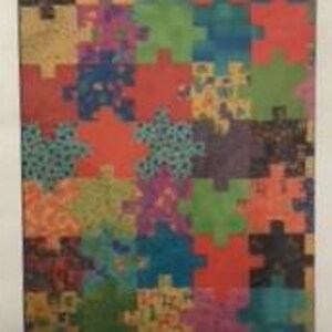 May include: A colorful jigsaw puzzle with interlocking pieces in various colors and patterns. The puzzle is labeled "JIGSAW" at the top, with the number "201" next to it. The puzzle pieces are red, green, blue, orange, purple, and yellow.