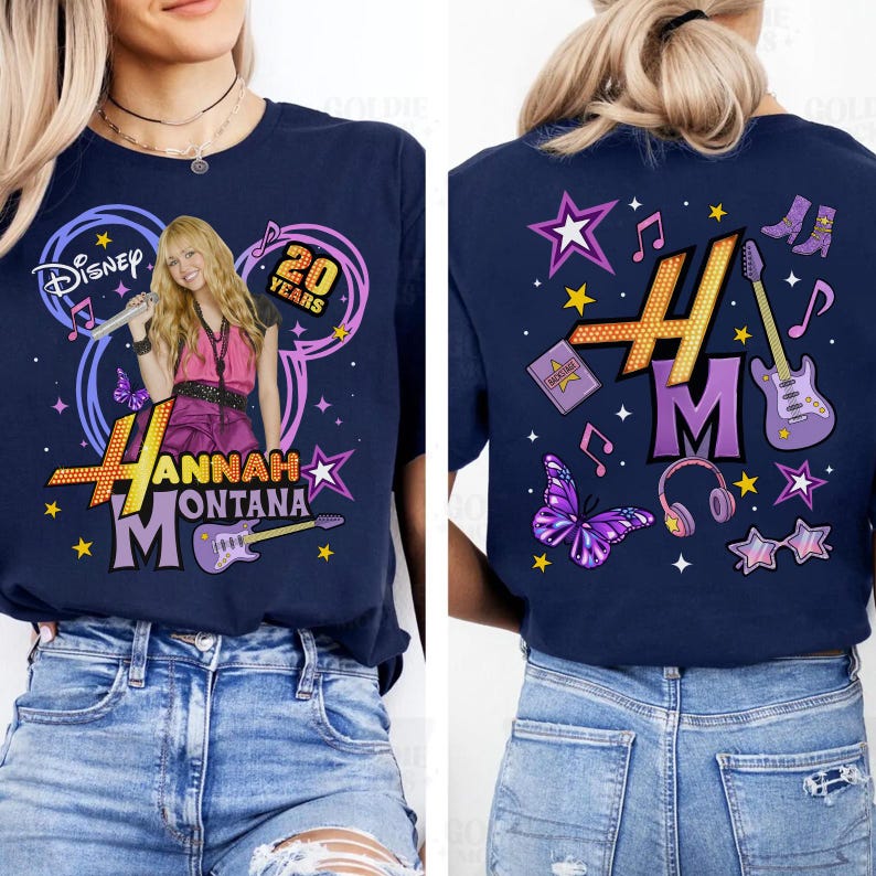 May include: Navy blue t-shirt featuring a graphic of Hannah Montana with the text "Hannah Montana" and "20 Years". The design includes a picture of Hannah Montana, a guitar, stars, and musical notes. The back of the shirt has a matching design.