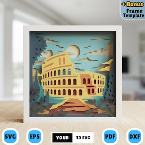 May include: A framed 3D paper art piece depicting the Colosseum in Rome. The artwork features layered paper cutouts in shades of yellow, orange, and brown against a blue sky background. The frame is white, and the artwork includes the text "YOUR 3D SVG".