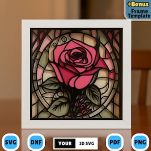 Può includere: Un'opera d'arte in carta 3D incorniciata con un design a rosa rosa a strati. L'opera d'arte ha uno sfondo in stile vetrata con sfumature verdi e crema. La cornice è bianca e l'immagine include il testo "+Bonus Frame Template".