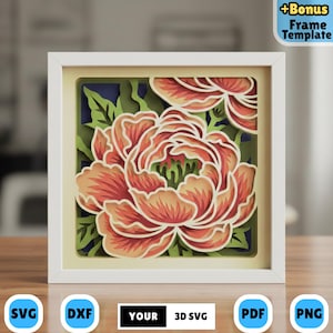 May include: A framed 3D paper art piece featuring a layered peony flower design in shades of orange, peach, and green. The artwork is set against a dark blue background within a white square frame. Text includes "+Bonus Frame Template", "SVG", "DXF", "YOUR 3D SVG", "PDF", and "PNG".