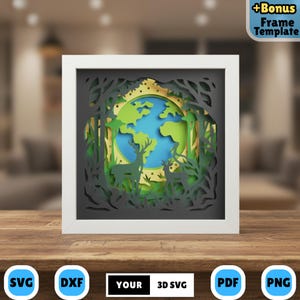 May include: A framed 3D paper art piece featuring a layered forest scene with deer and a globe. The artwork is in a white frame and includes the text "YOUR 3D SVG". The color palette includes green, blue, yellow, and black.
